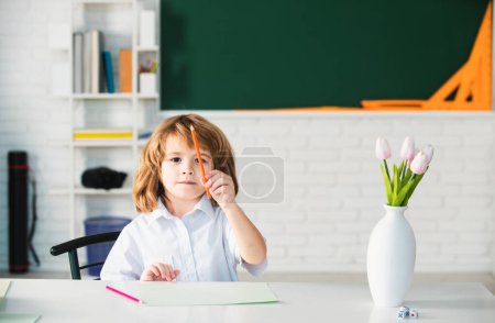 Photo for First grade. Kid studying at school. Schoolchild doing homework at classroom. Education for kids - Royalty Free Image