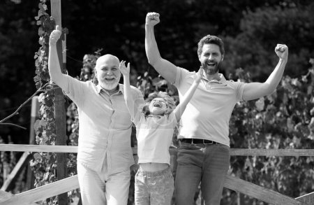 Excited grandfather father and son outdoors. Three men generation. Happy men family