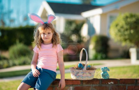 Photo for Easter children. Child in bunny ears hold Easter egg. Boy hunting easter egg - Royalty Free Image