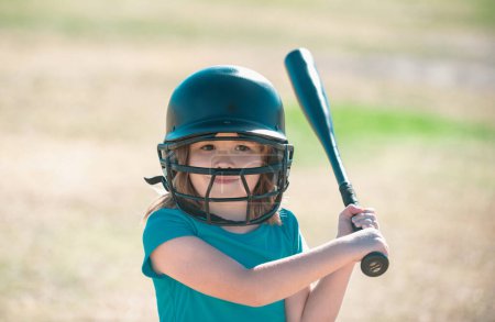 Little child baseball player focused ready to bat. Kid holding a baseball bat
