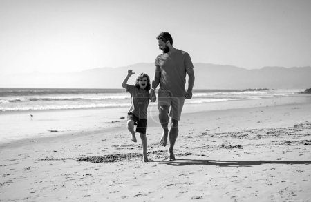 Photo for Father and son running on sea. Concept of friendly family and of summer vacation - Royalty Free Image