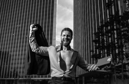 Photo for Worker celebrating successful ending, make deal dancing near office raised hands feels happy. Lucky applicant, after job interview, got new work - Royalty Free Image