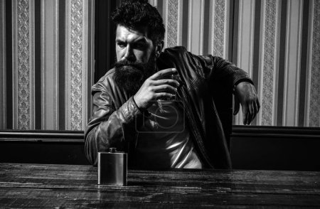 Photo for Bearded sman is drinking expensive whisky. Man with beard holds glass brandy. Elegant and stylish man in classical wear holding glass with wiskey - Royalty Free Image