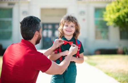 Photo for Happy father and son go to elementary school. Parent taking child to primary school. Positive human emotion - Royalty Free Image