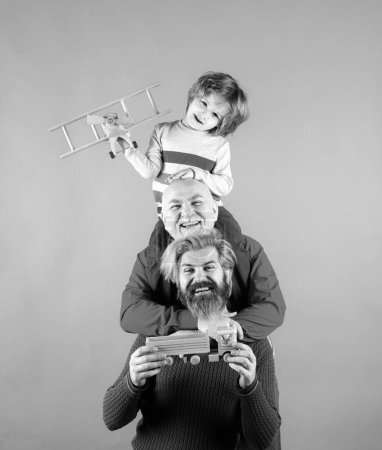 Father and child son playing with toy plane in studio. Journey travel trip concept. Isolated background