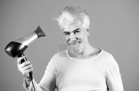 Photo for Blonde bearded man hair dry. Young man drying hair with hairdryer - Royalty Free Image