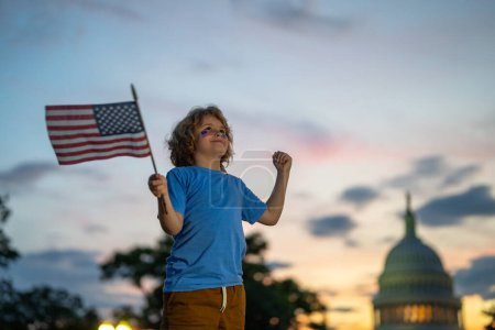 Photo for Child with American USA flag in Washington DC. Washington capital of USA. American people celebrate 4th of July. Kid hold the USA flag. Child wave Flag of the USA. America celebrate 4th of July - Royalty Free Image