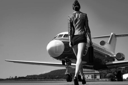 Photo for Profession stewardess. Air hostess. Female flight attendant. Air stewardess. Travel concept. Commercial airplane flying with beautiful charming stewardess. Fly plane and stewardess attendant concept - Royalty Free Image