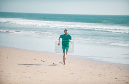 Photo for Man running on beach. Jogging on a sandy beach near sea or ocean - Royalty Free Image