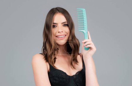 Woman brushing straight natural hair with comb. Girl combing long healthy hair with hairbrush. Hair care beauty concept. Brushing Hair