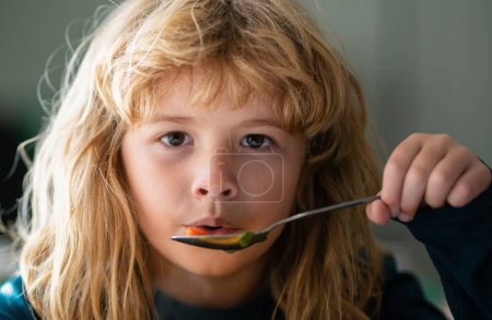 Photo for Child have a breakfast. Tasty kids breakfast. Adorable little school boy eating vegetable soup indoor. Childcare and childhood - Royalty Free Image