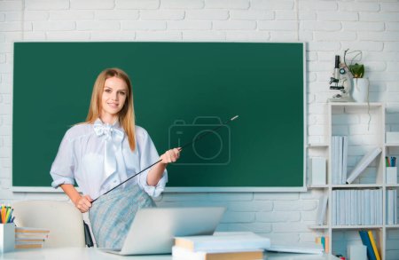 Photo for Successful female student at classroom of university. High school student learning english or mathematics in class - Royalty Free Image