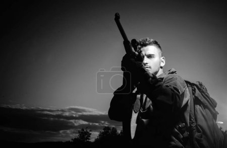 Barrel of a gun. Hunter with shotgun gun on hunt. Hunter with Powerful Rifle with Scope Spotting Animals