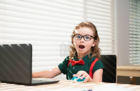 Photo for Education and distance learning for kids, homeschooling. School child watching online education class on the internet at home - Royalty Free Image