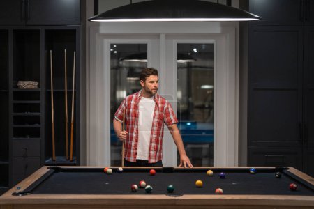 Photo for Man playing billiards in the billiard club - Royalty Free Image
