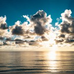 Sunset sea landscape. Colorful beach sunrise with calm waves. Nature sea sky. range and golden sunset sky calmness tranquil sunlight summer mood. Sunrise with clouds of different colors