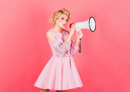 Woman girl posing on isolated background studio with megaphone. Screaming in megaphone. Beauty woman with megaphone isolated on pink
