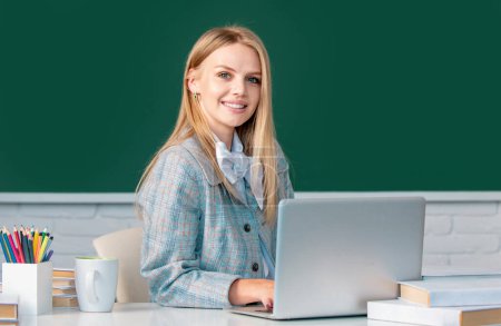 Photo for Portrait of female university student study lesson at school or university on blackboard background - Royalty Free Image