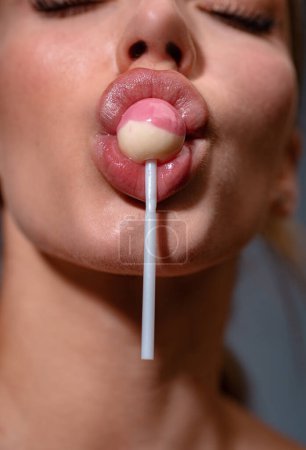 Lollipop in woman mouth. Girl lick lollipop, close up. Mouth lick suck chupa chups