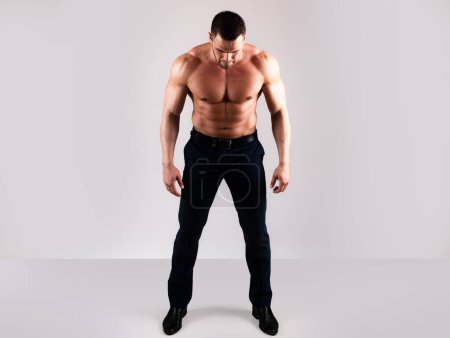 Photo for Strong man showing his perfect naked body. Bare torso. Sexy muscular guy. Full length - Royalty Free Image