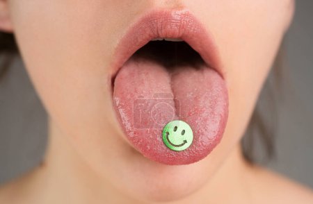 Tongue with drugs. LSD. Psychedelic hallucinogens Drug addiction