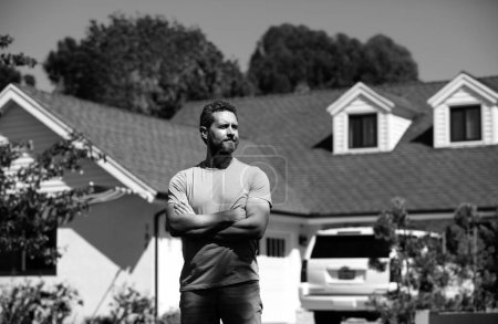 Photo for Man real estate, rental house. Portrait of confident man standing outside new home. Successful real estate agent purchasing house for investment purpose - Royalty Free Image