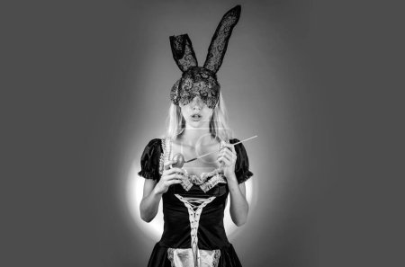 Photo for Sexy woman with bunny ears holding colorful Easter eggs looking at camera copy space. Expression face. Easter bunny. Beautiful sensual blonde - Royalty Free Image