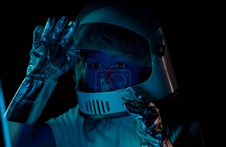 Photo for Kid boy exploring space. Portrait of cute kids in space suits. Cosmonautics day concept. Close up excited kids face on neon color - Royalty Free Image