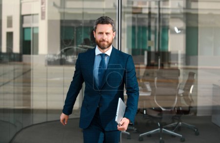 Photo for Office worker near the business center. Businessman standing on the city street near business center - Royalty Free Image