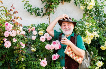 Photo for Senior man relaxing in his garden. Senior gardener is enjoying his work in garden - Royalty Free Image