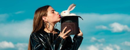 Photo for Easter banner with bunny woman. Magician rabbit, stylish clothing. Alice in Wonderland. Plush bunny. Fashion concept - Royalty Free Image