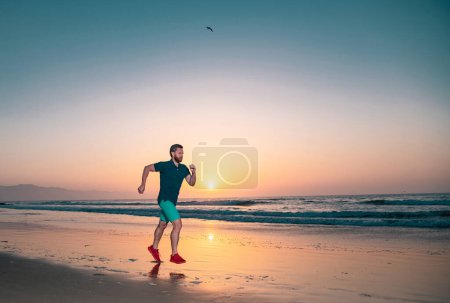 Photo for Runner man on the beach be running for exercise. Active healthy runner jogging outdoor. Young man training on the beach in morning - Royalty Free Image