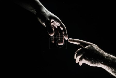 Téléchargez les photos : Two hands at the moment of farewell. The holding hands of relations. Help friend through a tough time. Rescue gesture, support, friendship and salvation concept. Hand creation of adam - en image libre de droit