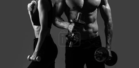 Photo for Sport couple exercising with dumbbell. Slim and healthy sexy girl with strong muscular man workout. Muscular sexy couple body - Royalty Free Image