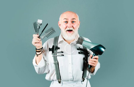 Téléchargez les photos : Vieux excité barbier étonné avec des outils d'équipement de coiffeur - en image libre de droit