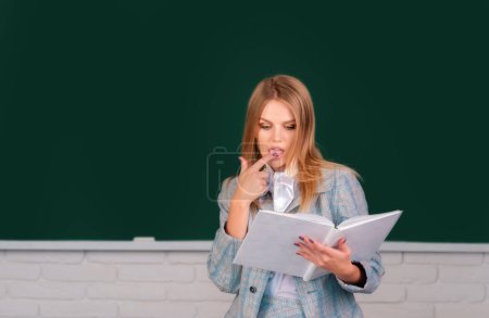 Photo for Portrait of female university student reading book study lesson at school or university - Royalty Free Image