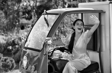 Smiling amazed young woman draver in electro car. Saving ecology. Electric cars