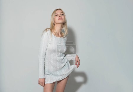 Photo for Woman in knitted sweater. Young glamour woman wearing stylish fashion dress. Fashion model in studio - Royalty Free Image