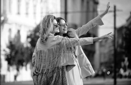 Photo for Excited girls friends walking on city. Outdoor portrait of caucasian young women enjoying good day. Happy leisure, carefree weekend and romantic holiday - Royalty Free Image