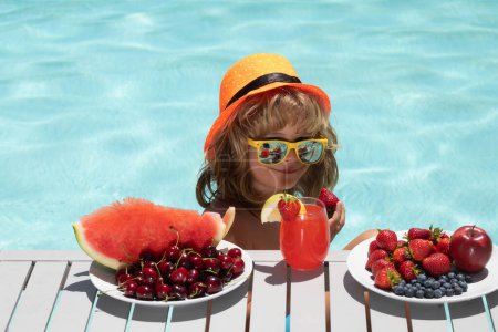 Photo for Healthy food. Strawberry, watermelon, cherry and blueberry. Outdoor leisure activity with kids by swimming pool. Summertime. Child in swimming pool with summer fruits. Kids summer vacation - Royalty Free Image