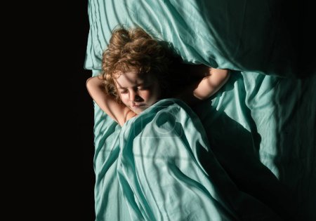 Foto de Niño durmiendo en la cama en el dormitorio en casa - Imagen libre de derechos