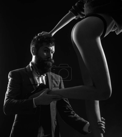 Photo for Passionate couple concept. bearded man in formal suit. female legs in sexy shous. office romance. couple in love. businessman. striptease. let me love you. Loving everything about her. fetish - Royalty Free Image