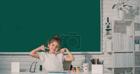 Foto de Niña dibujo con plumas para colorear paintind. Retrato de la adorable niña sonriendo felizmente mientras disfruta de clases de arte y artesanía en la escuela. Niños arte, creatividad niños - Imagen libre de derechos