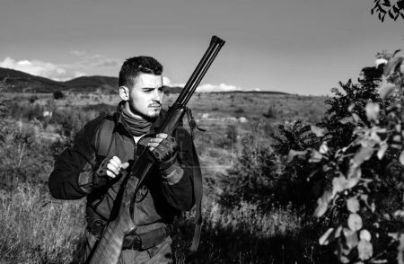 Jäger mit Gewehr auf Jagd. Hirschjagd. Jäger in Tarnkleidung bereit zur Jagd mit Jagdgewehr