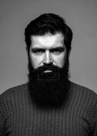 Photo for Portrait of confident serious man has beard and mustache, looks seriously, isolated. Hipster thinking with expression looking. Handsome male model, closeup face - Royalty Free Image