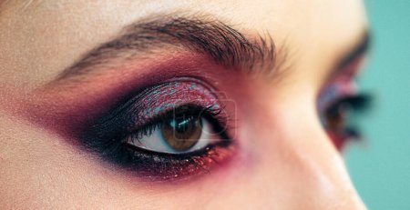 Photo for Professional smokey eyes make up at beautiful girl for special occasion. Shiny glitter pigments in eyes make up. Luxury eye makeup concept. Purple smokey eyes makeup close up photo - Royalty Free Image