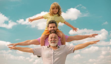 Father, son and grandfather happy multi genration family with aising hands or open arms flying on sky. Generations men