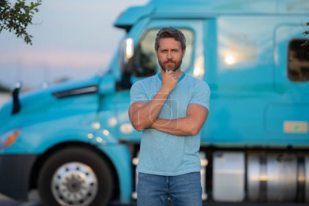 Photo for Men driver near lorry truck. Man owner truck driver in t-shirt near truck. Handsome middle aged man trucker trucking owner. Semi trailer, semi trucks. Handsome man posing in front of truck - Royalty Free Image