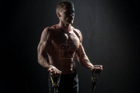 Photo for Man exercising suspension training trx. Sexy muscular man doing suspension training. Sport. Men training with fitness trx straps in the gym. Guy exercising her muscles sling or suspension straps - Royalty Free Image