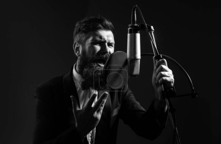 Photo for Music festival. Singer performing a song with a microphone while recording in a music studio - Royalty Free Image